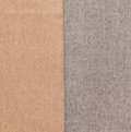 Beige and gray reversible baby alpaca throw blanket draped over sofa in modern living room