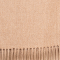 Light cinnamon baby alpaca throw blanket folded on bed with warm neutral decor